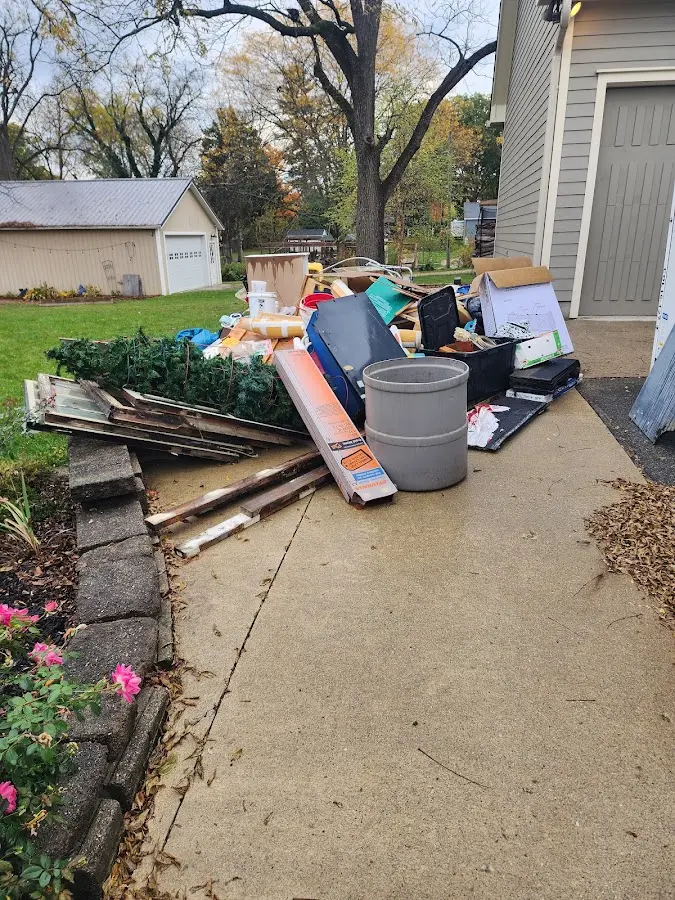 Dumpster being loaded with debris for Estate Cleanout Dumpster Rental in Kensington Park